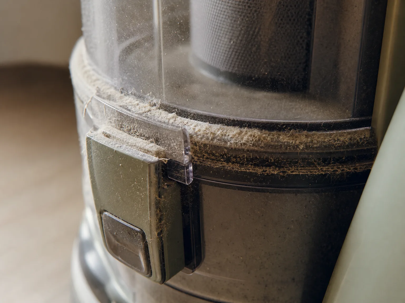 Fine dust visible on the exterior of the Eureka canister and the connection joint after vacuuming